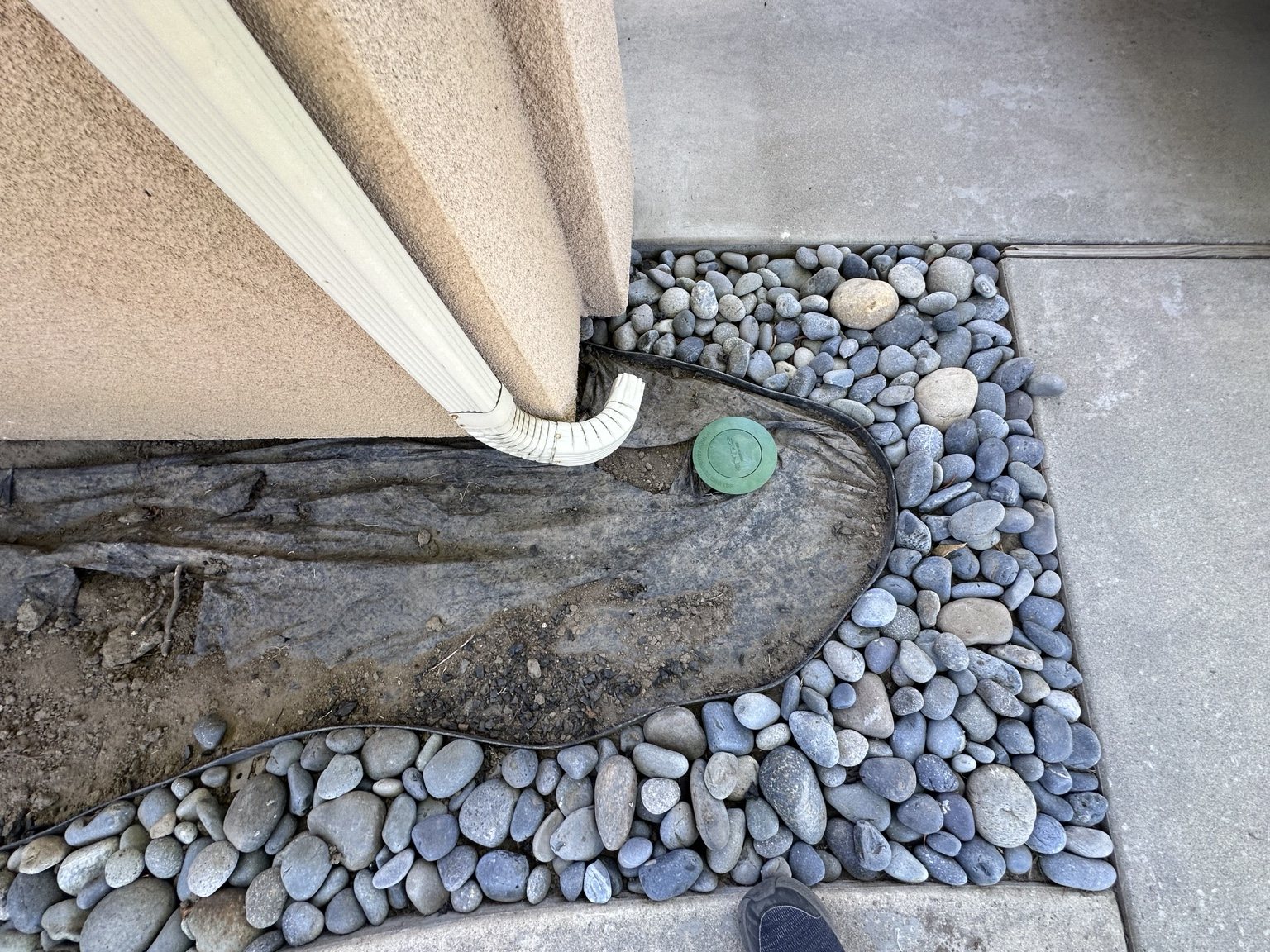 Close-up of downspout and drainage routing