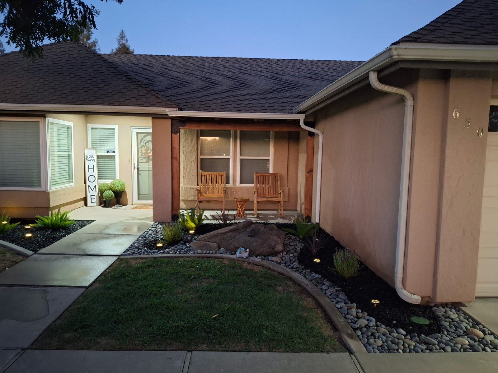 Finished exterior drainage and landscape area at night